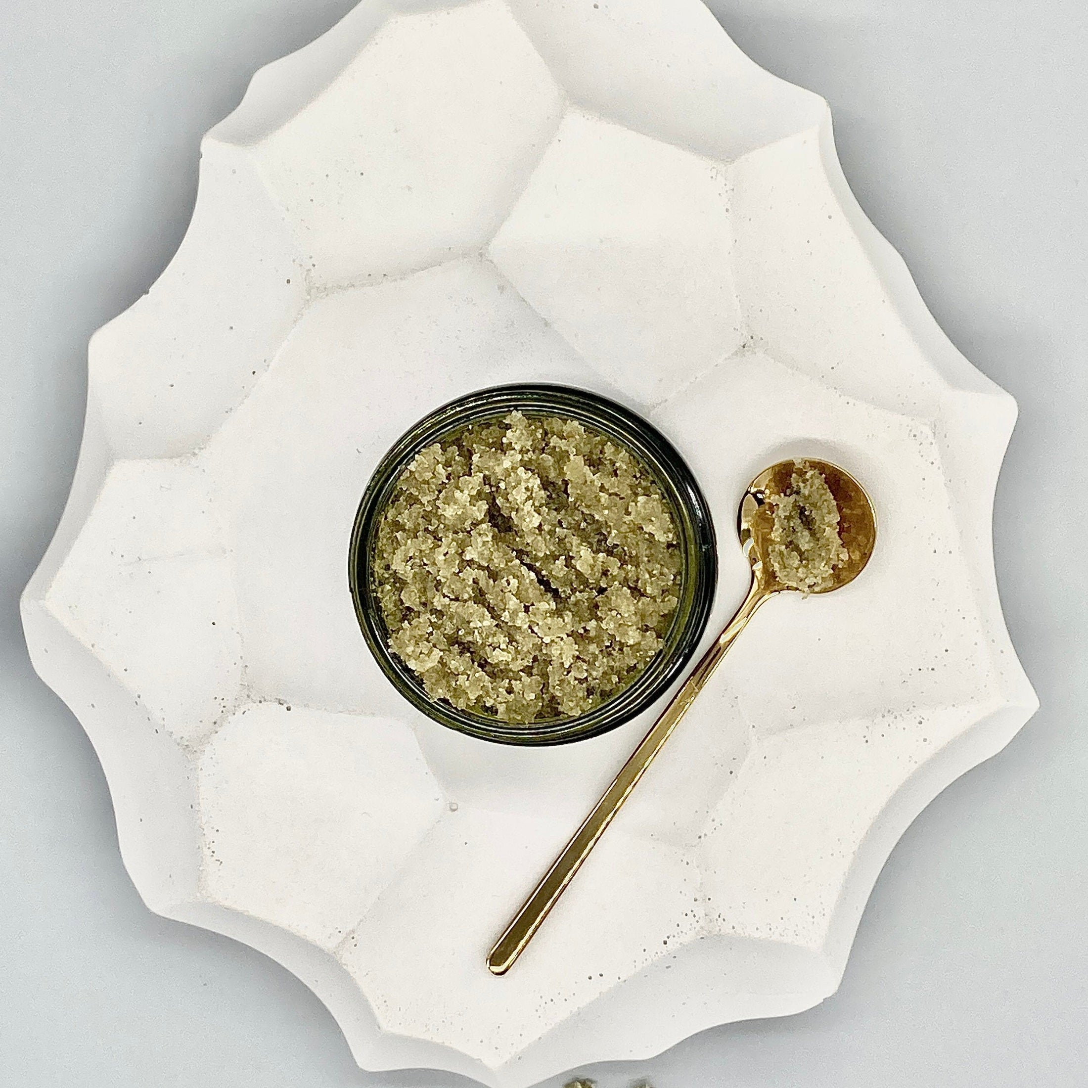 Top View Of Open Jar And Spoonful of Sea-Luxe Body Scrub