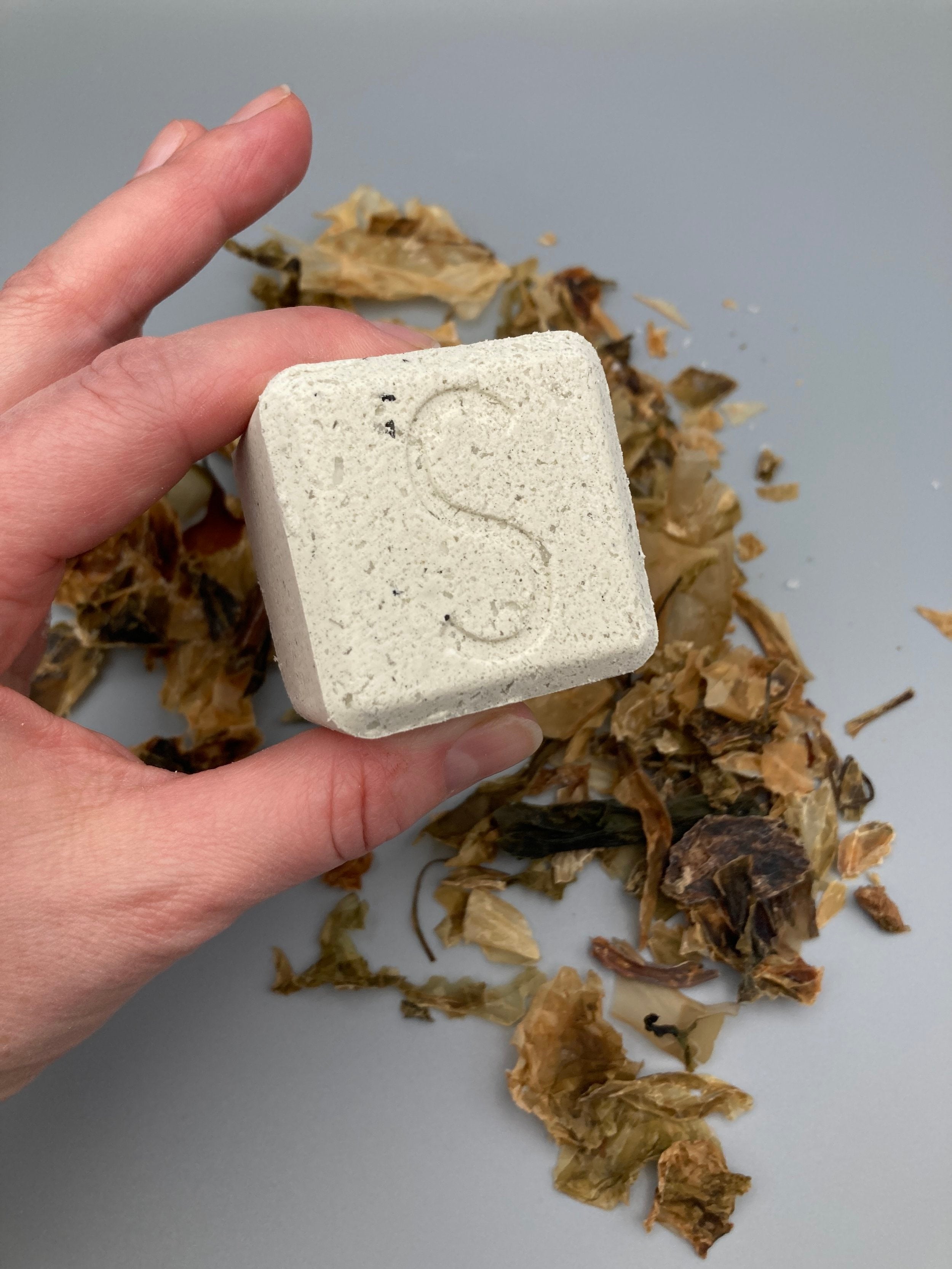 Seatox Bath Drop being held by woman's hand.