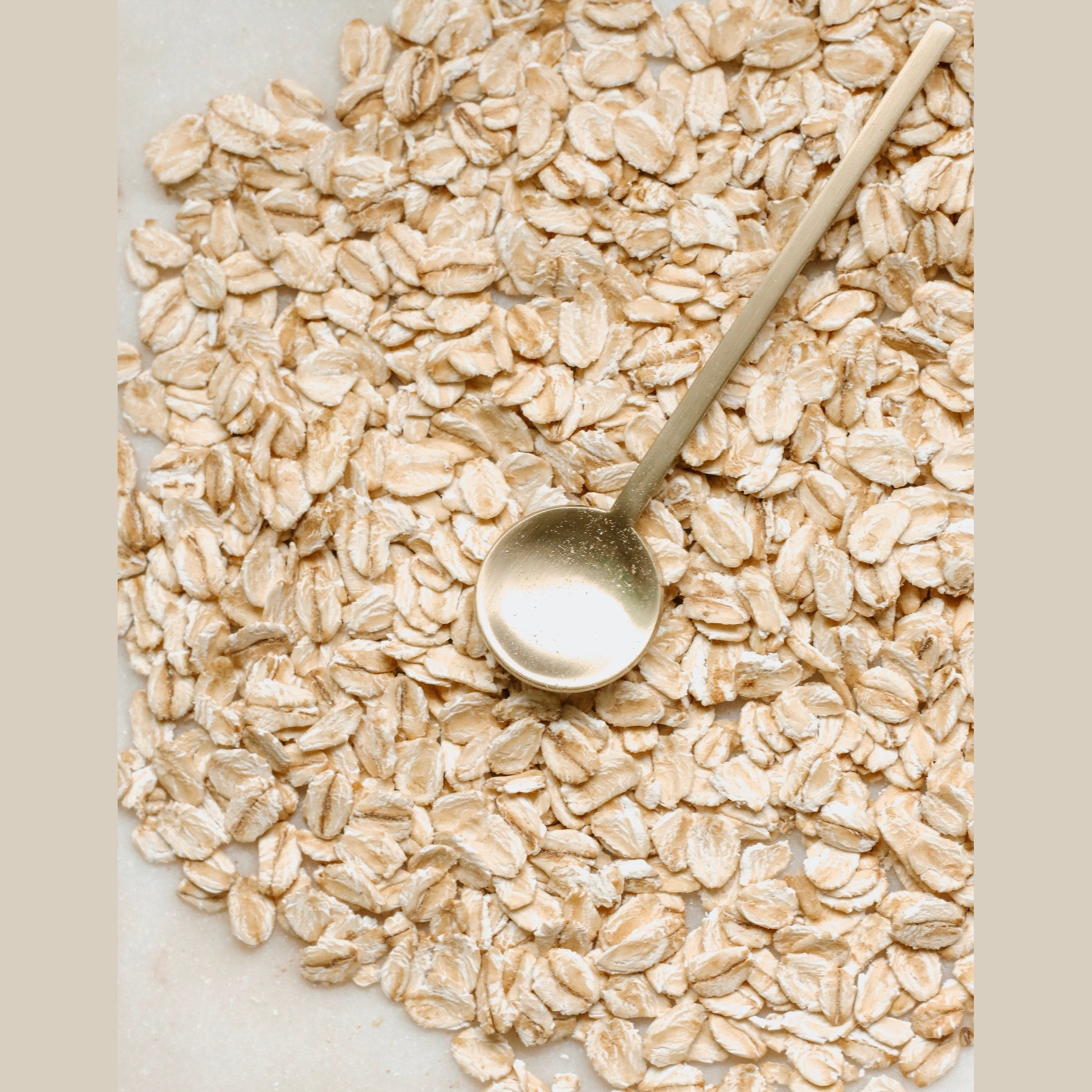 Round spoon on top of rolled oats.