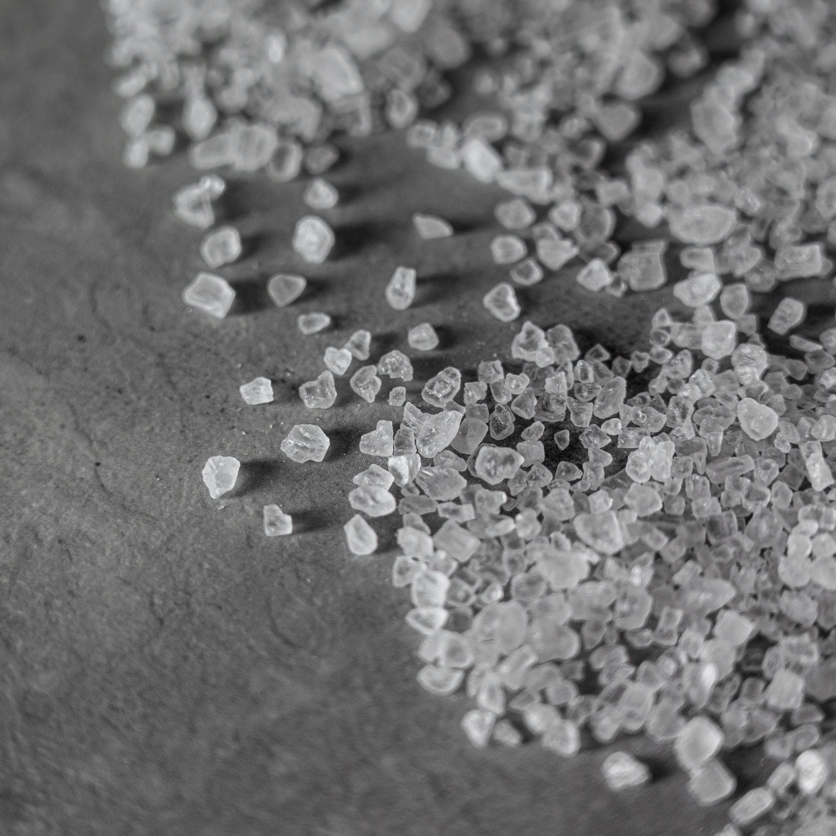 Black and white close up image of sea salt crystals.