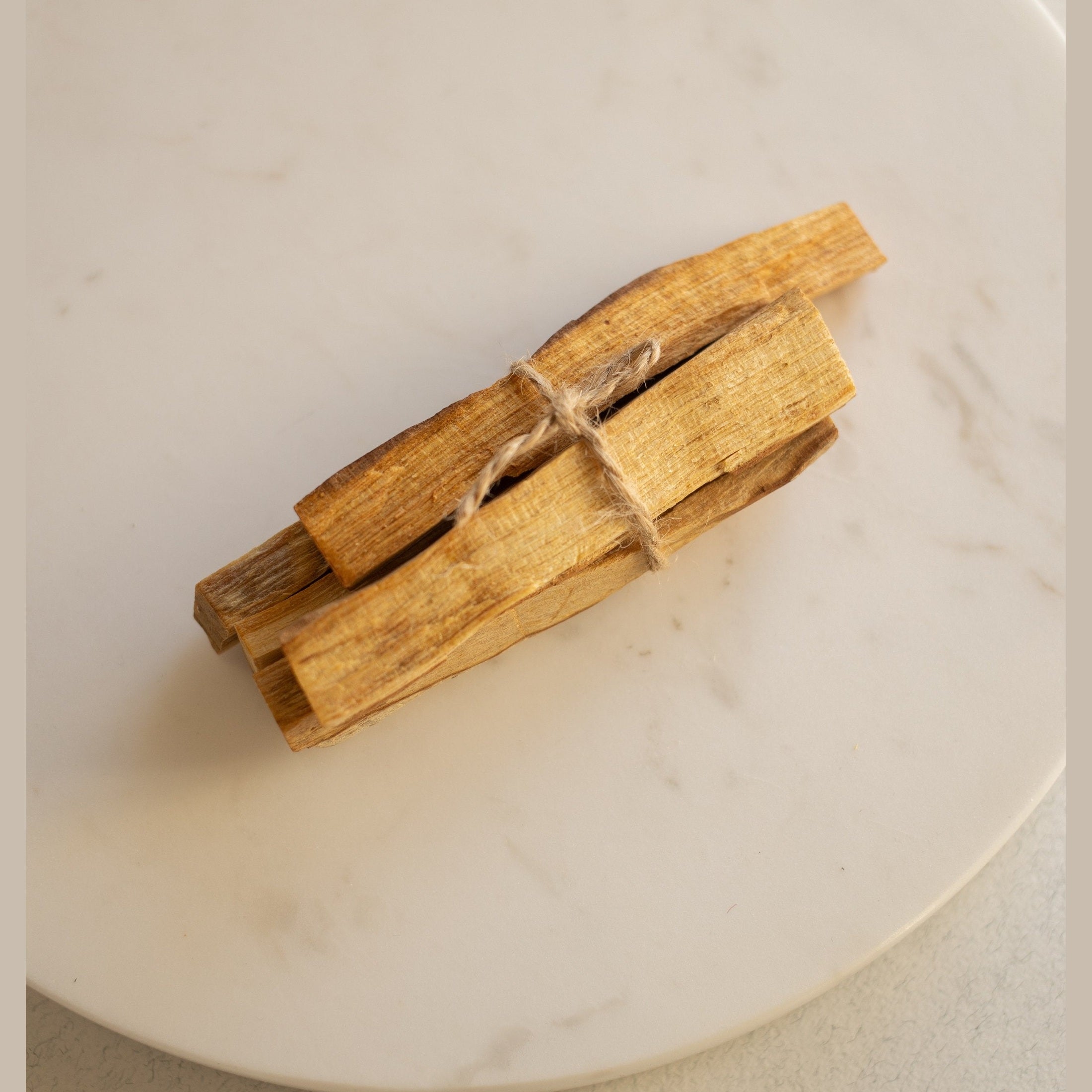 Small tied bundle of Palo Santo wood samples.