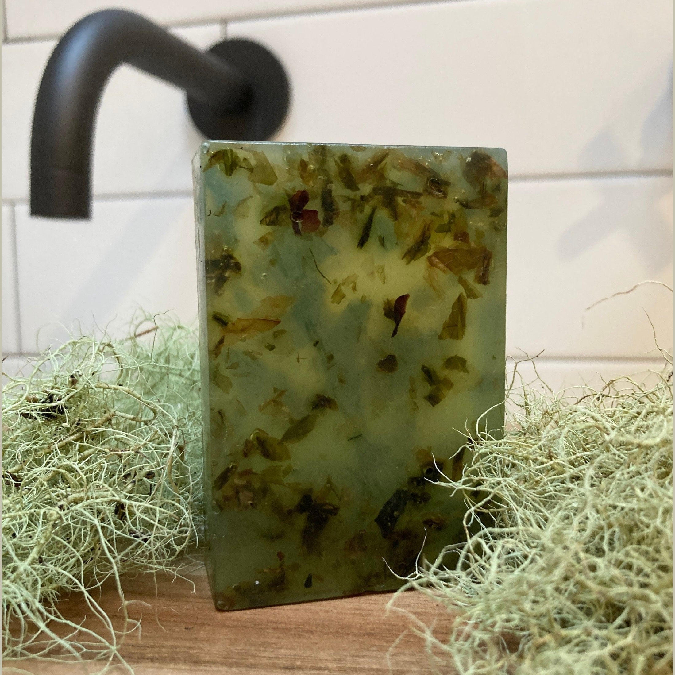 Seaweed soap bar near dried sea grass in a luxury bathroom.