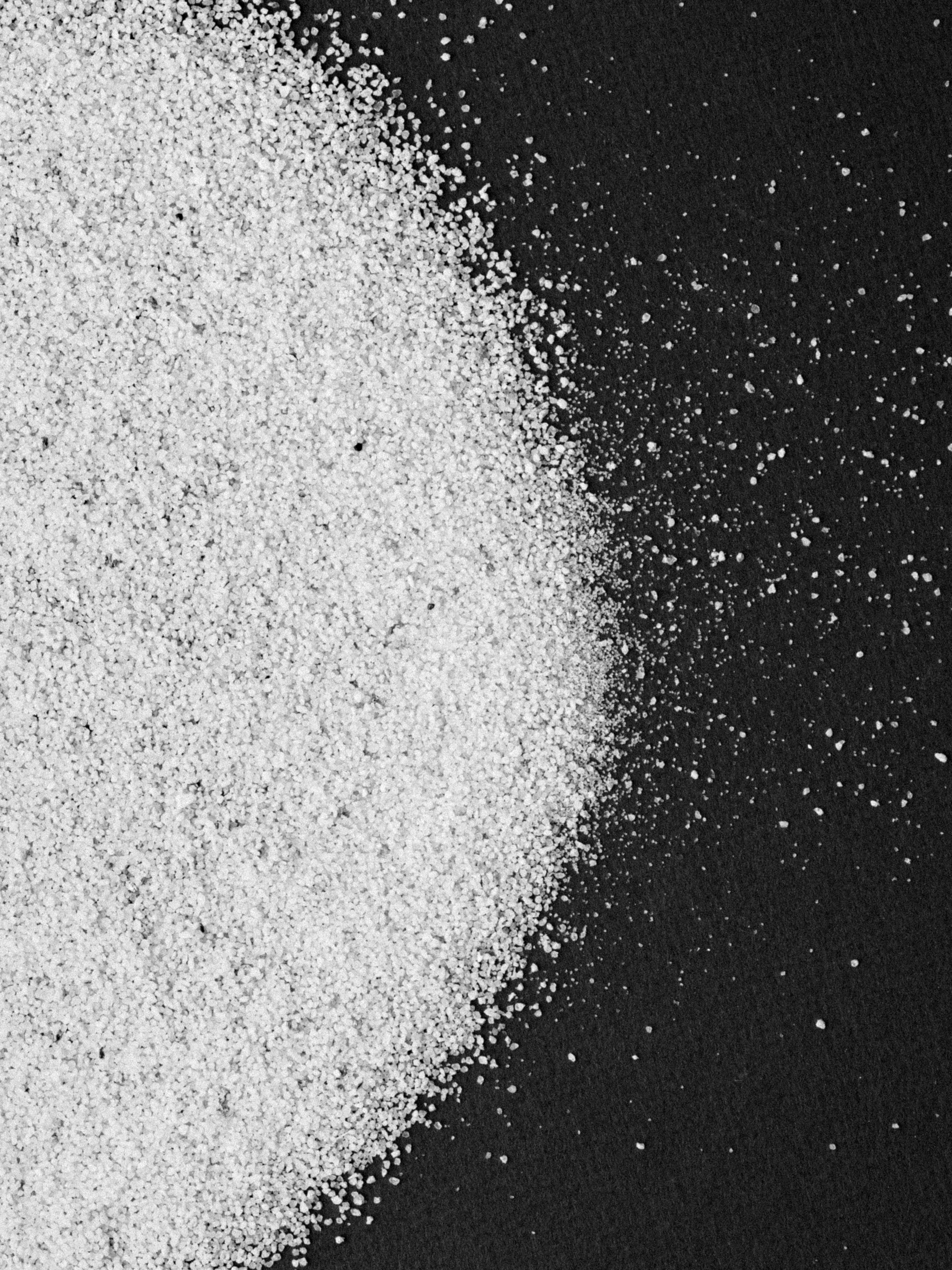 Close up of white powder on black cloth.